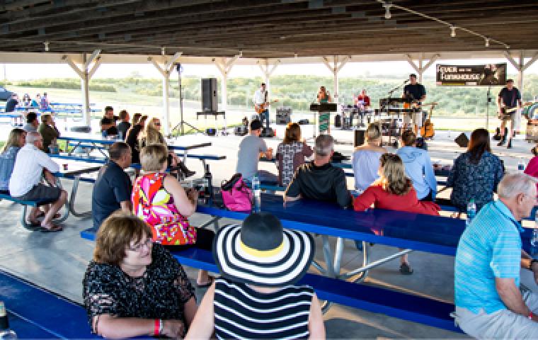 people sitting on benches at music event